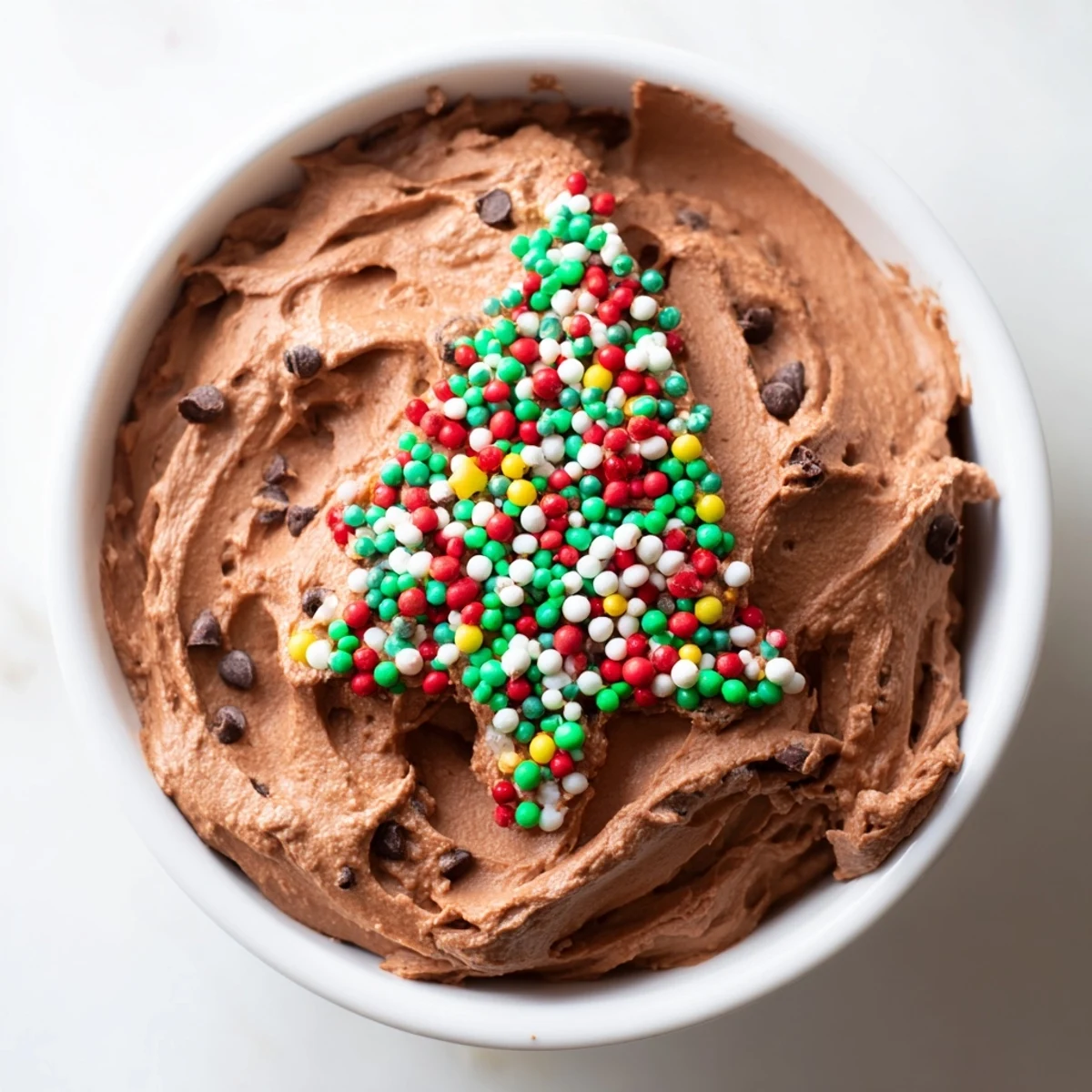 A festive view of the holiday-ready Festive Tree Brownie Dip, served with pretzels and fresh strawberries.