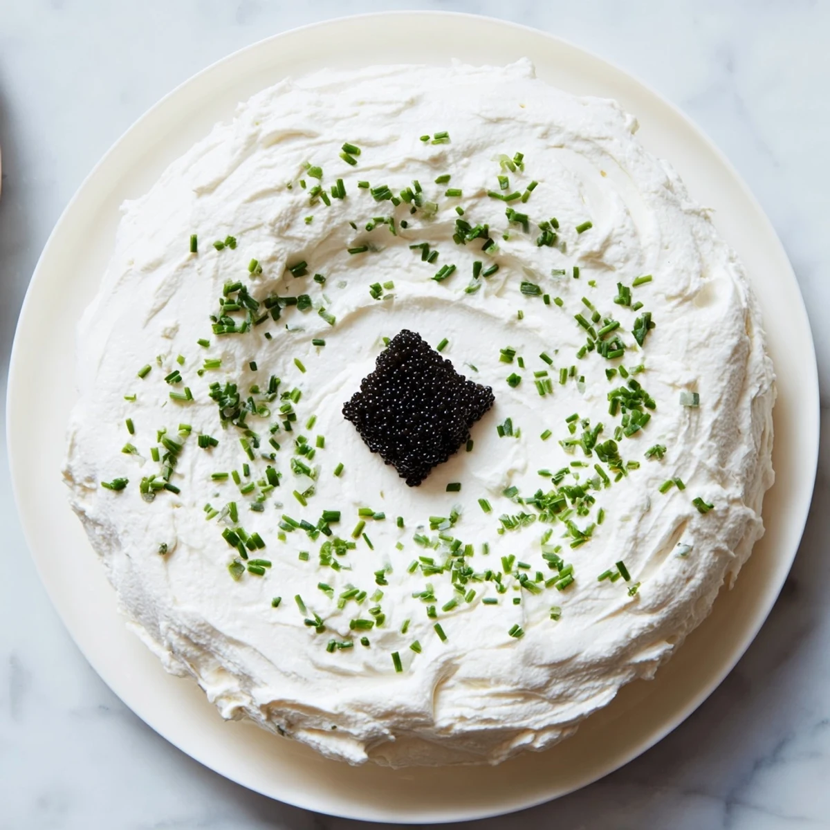 The Diamond Inlay appetizer featuring caviar, creamy cheese, and fresh herbs, ready to serve.