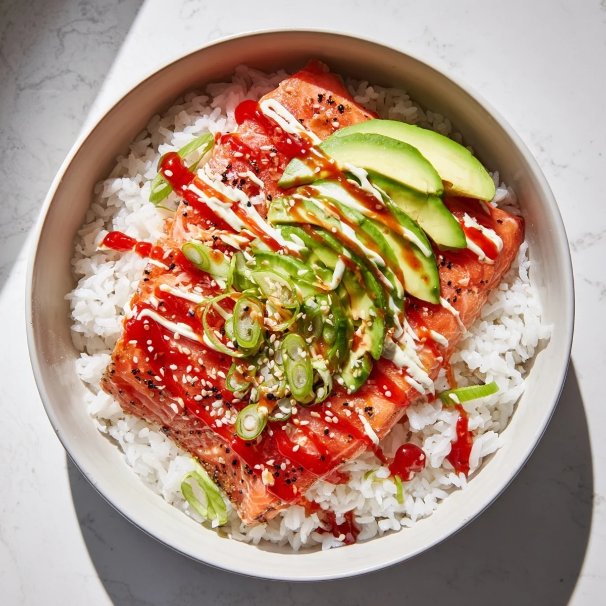 Flaky salmon and rice compose the Classic Salmon Rice, topped with creamy avocado and sesame seeds.