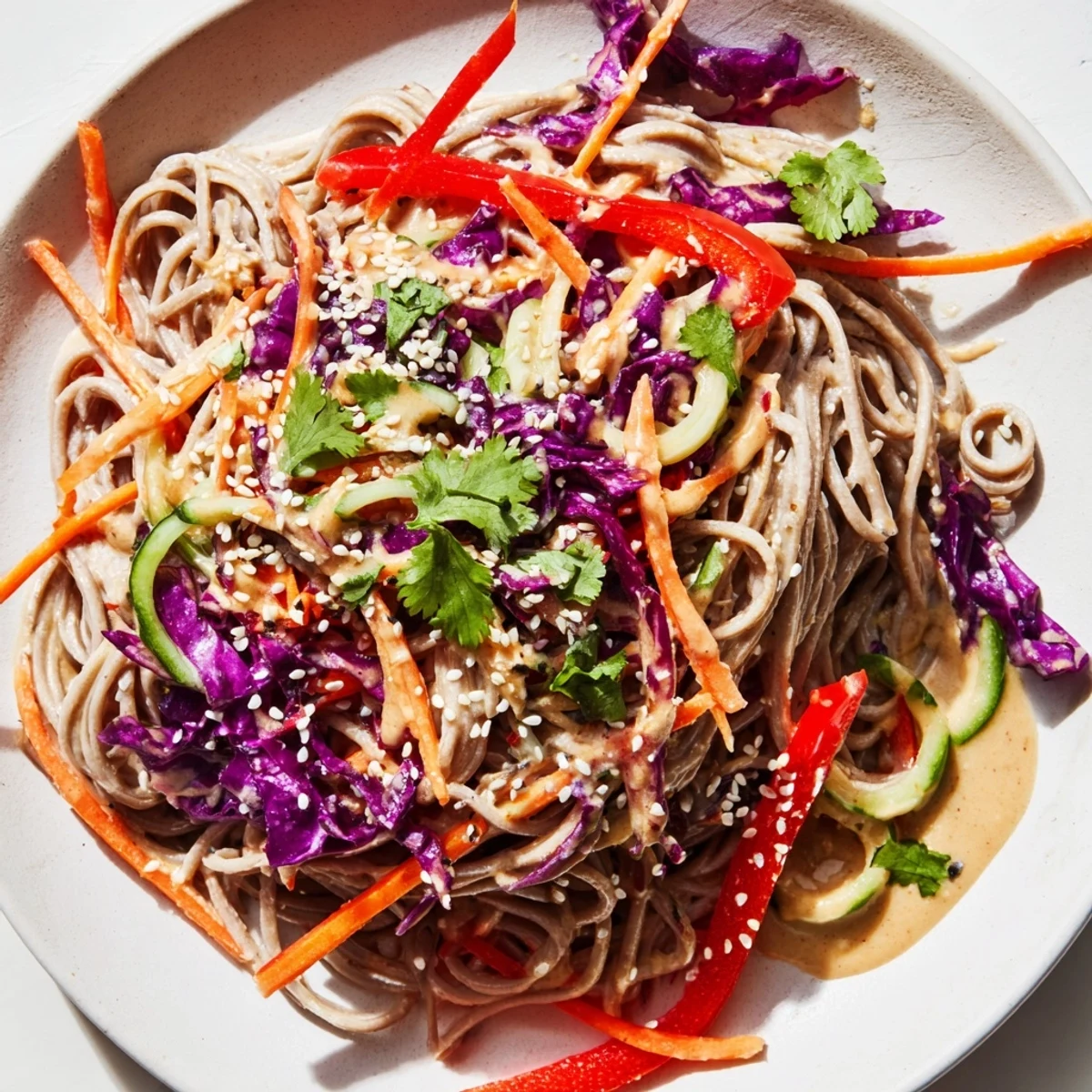 Close-up of a colorful soba noodle salad, showcasing the noodles and crisp vegetables.