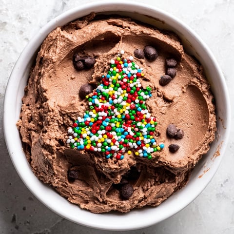 Festive Tree Brownie Dip, a creamy dessert perfect for holiday dipping with chocolate chips and sprinkles.