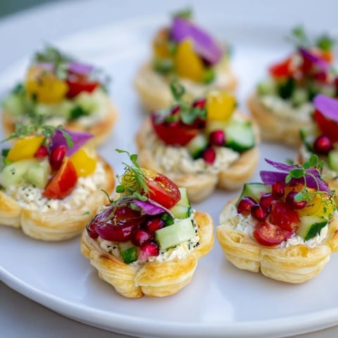 Golden, flaky Savory Tartlets: Mini Tart Wreath Appetizers, overflowing with colorful, festive vegetable toppings.