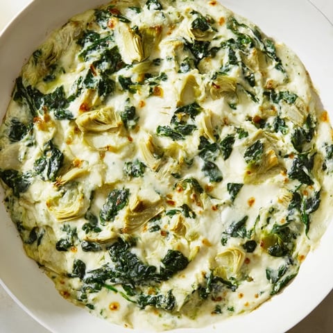Creamy, bubbling spinach artichoke dip, served hot with golden toasted baguette slices.