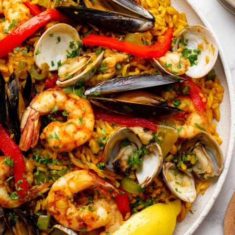 A colorful Spanish seafood paella with shrimp and mussels, ready to be enjoyed.