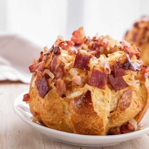 Steaming German Bread & Bacon Dumplings, ready to be enjoyed with flavorful bacon and onion.