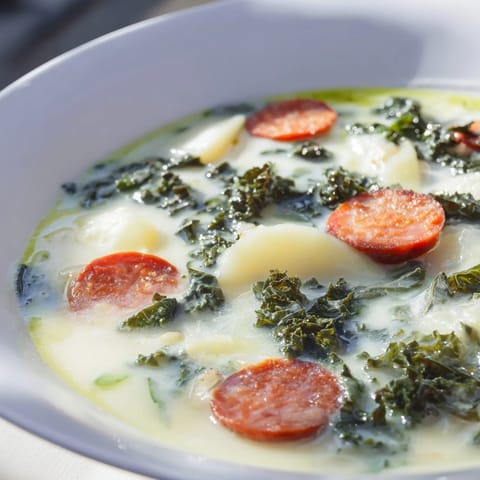 Smoky chorizo and potatoes simmer in this hearty Portuguese Caldo Verde, perfect for a cozy dinner.