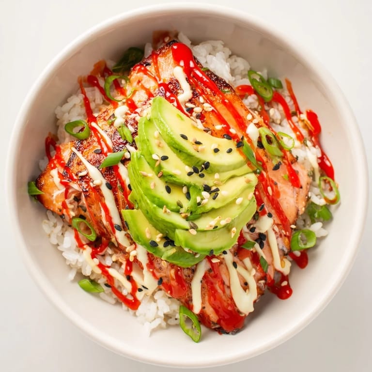 Flavorful Classic Salmon Rice is shown, a quick meal with salmon, soft rice, and vibrant toppings.